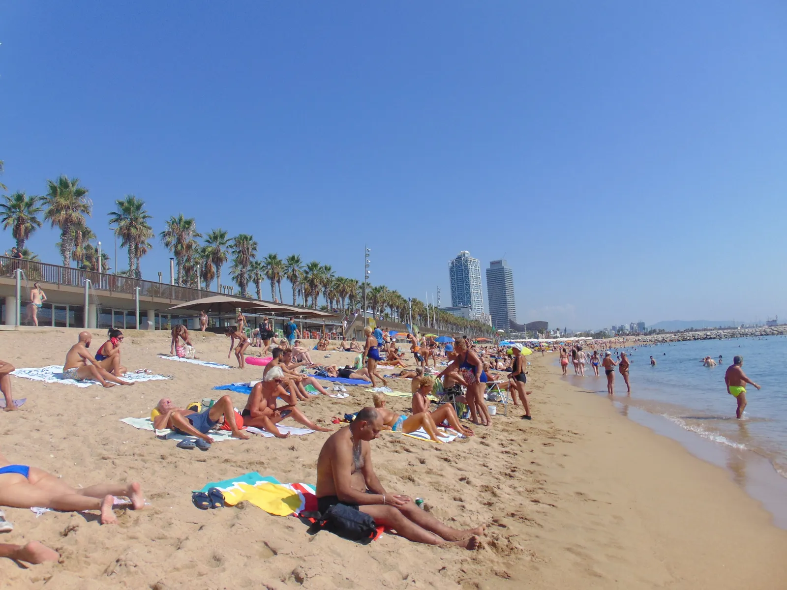 Barceloneta beach in Barcelona with the city skyline visible along the shore