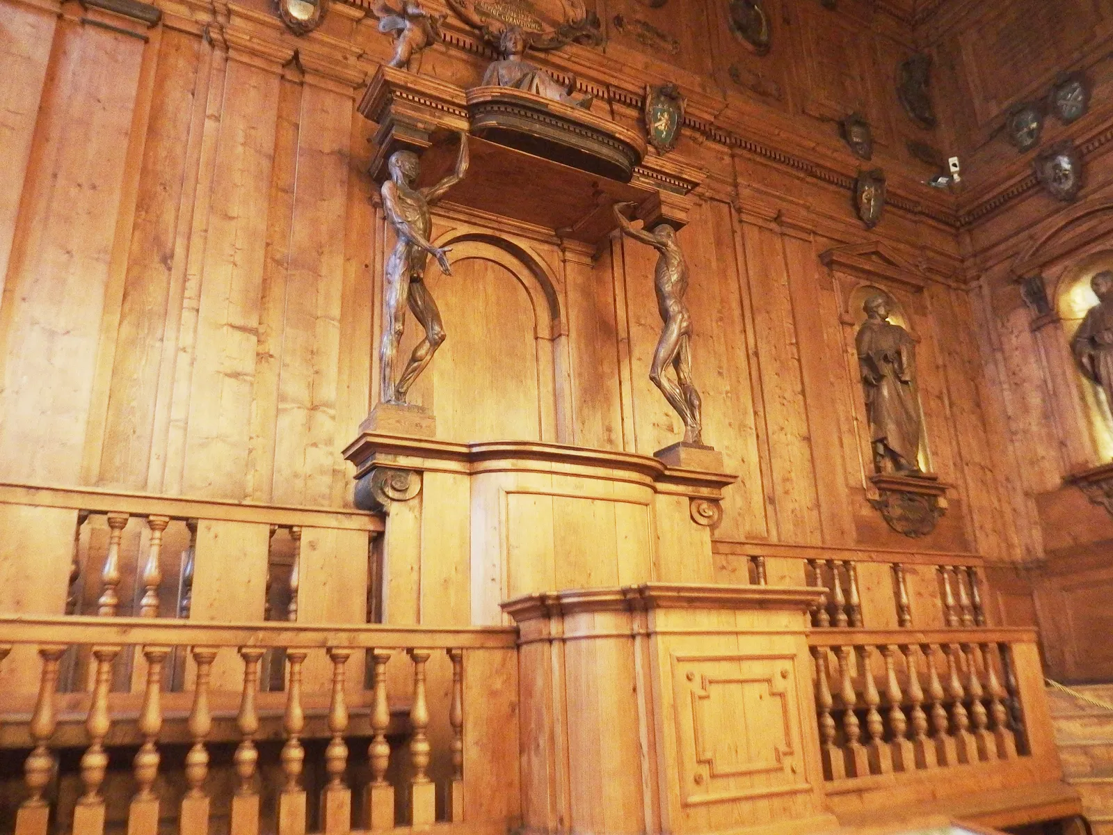 The wood-panelled Anatomical Theatre in Bologna's Archiginnasio, with the lecturer's canopied chair held up by two carved figures of skinned men