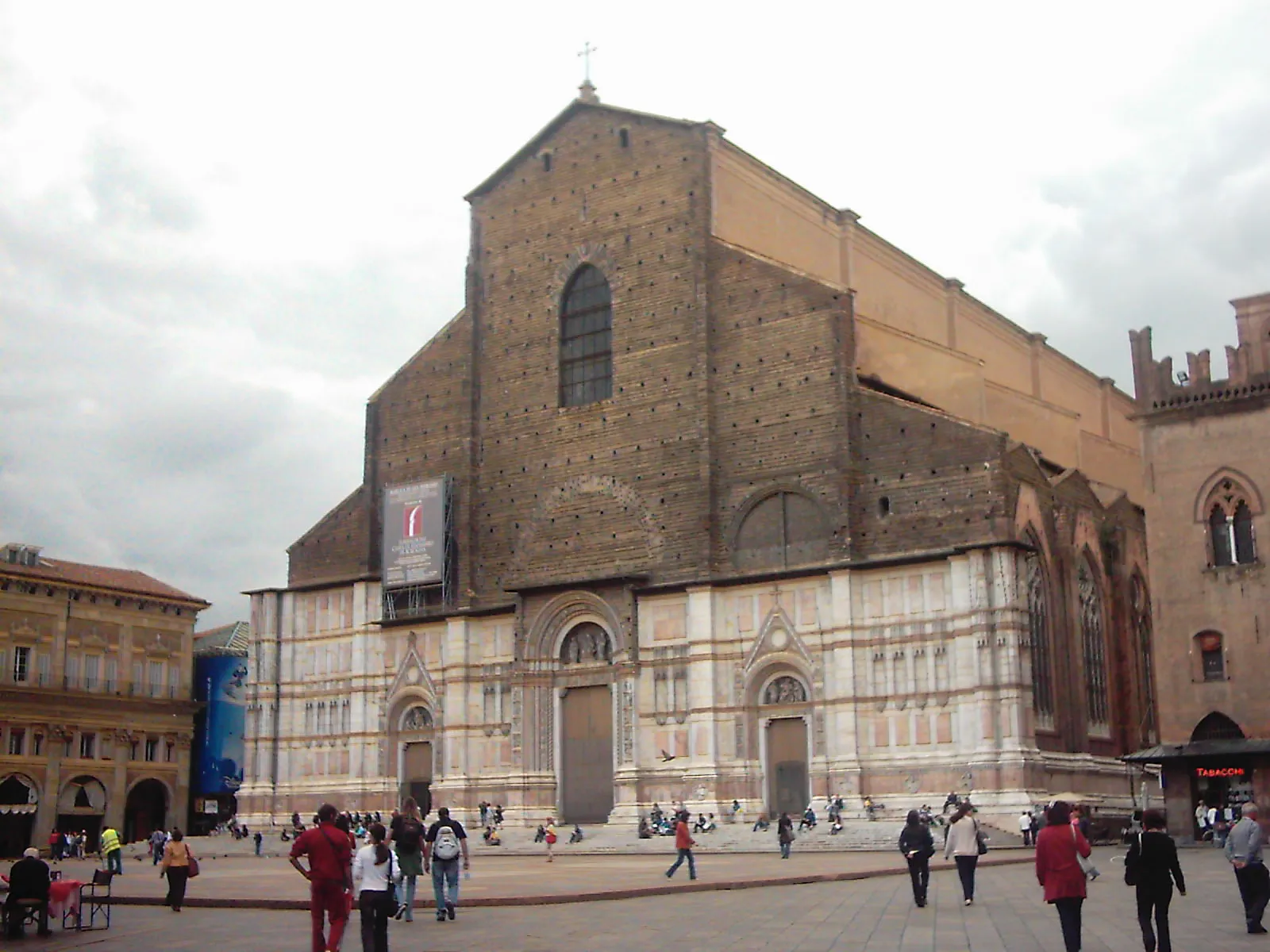 The facade of the Basilica of San Petronio on Piazza Maggiore in Bologna, faced in pale marble on its lower half and left as bare brick above