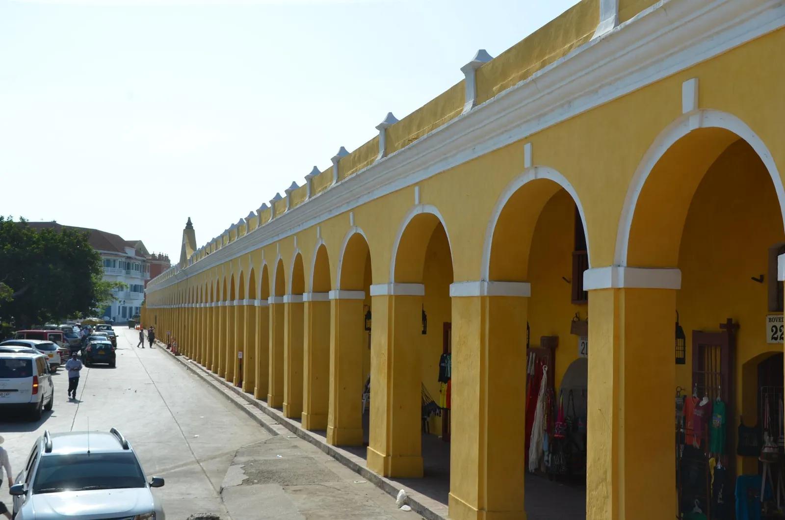 The long yellow arcade of Las Bovedas in Cartagena, a row of arched former dungeon cells built into the city wall and now fronted by souvenir shops