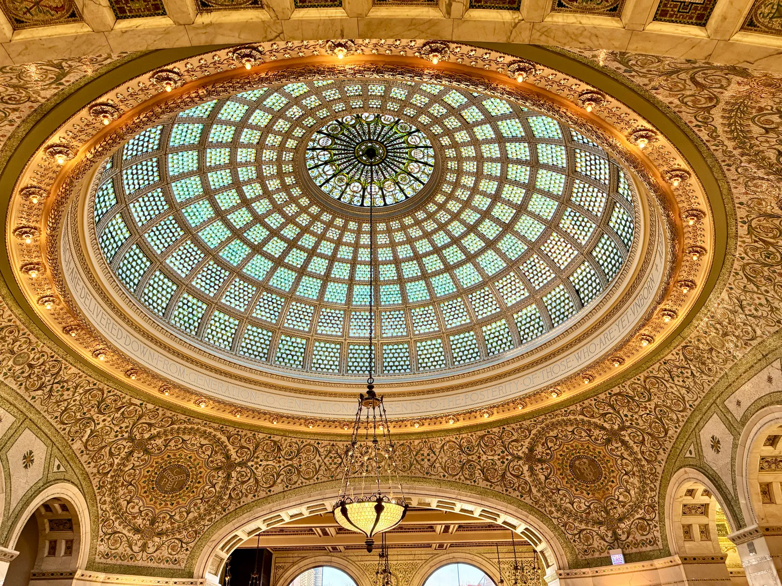 The Tiffany glass dome above Preston Bradley Hall in the Chicago Cultural Center, a circular canopy of pale green and blue glass set in gilded plasterwork