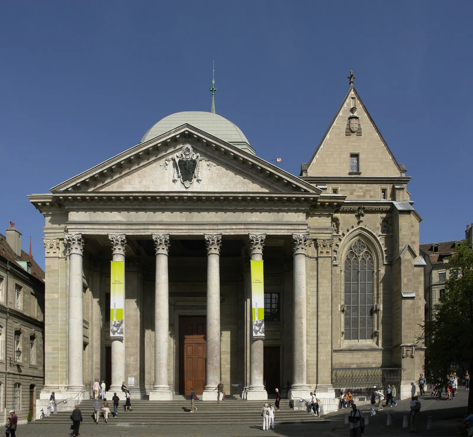 The neoclassical portico of St-Pierre Cathedral in Geneva, six tall columns under a triangular pediment with the older Gothic transept and its pointed window standing to one side