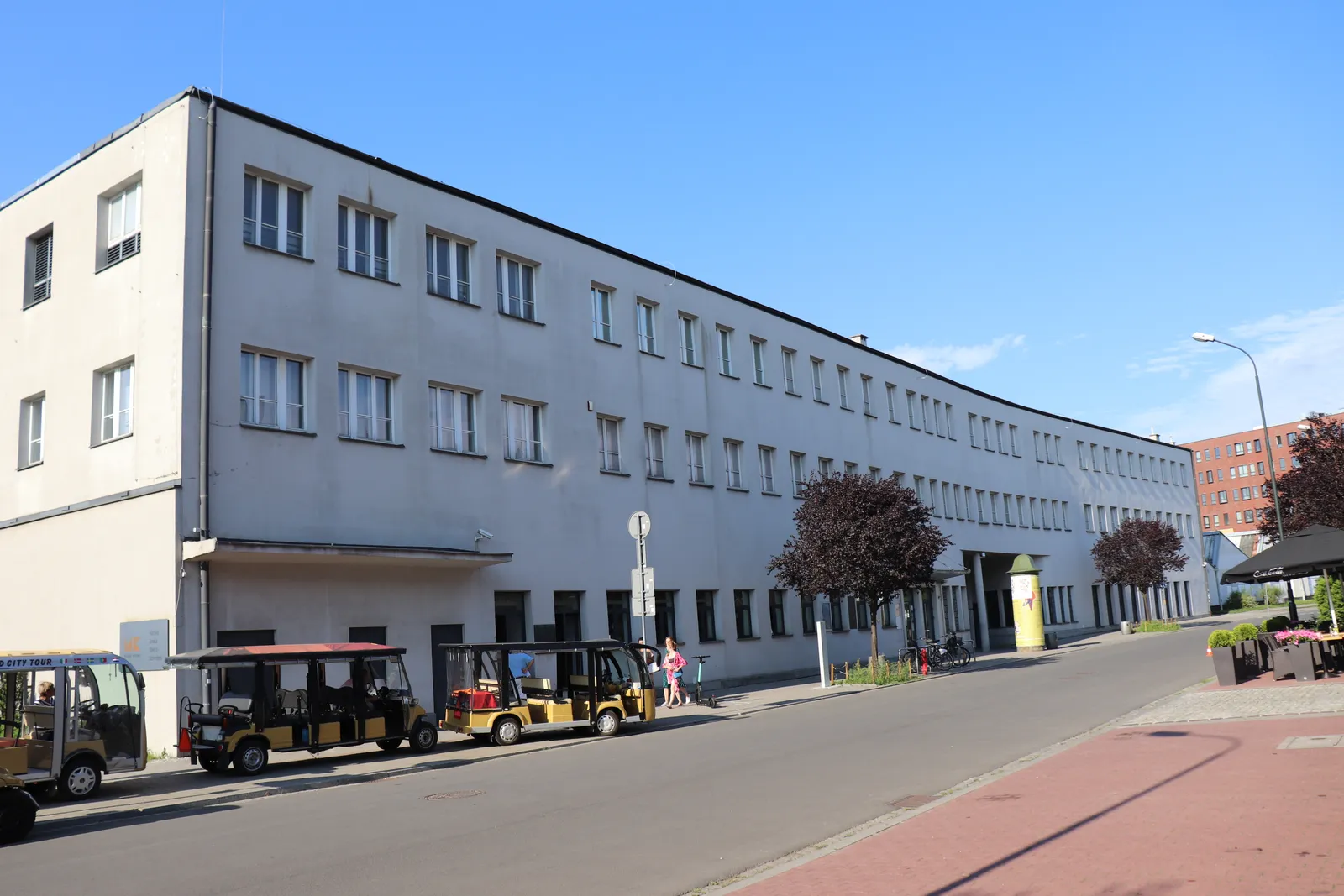 The long white administrative block of Oskar Schindler's former enamel factory on Lipowa Street in Kraków, four storeys of small square windows running the length of the building