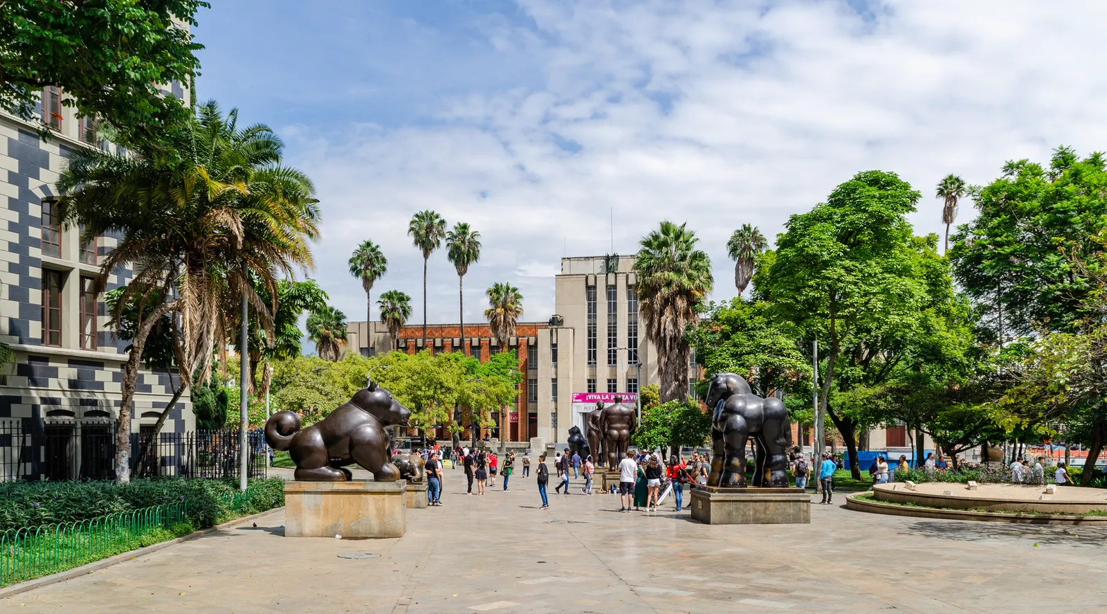 Plaza Botero in downtown Medellín, with two of Fernando Botero's rounded bronze sculptures in the foreground and the Palacio de la Cultura's towers behind