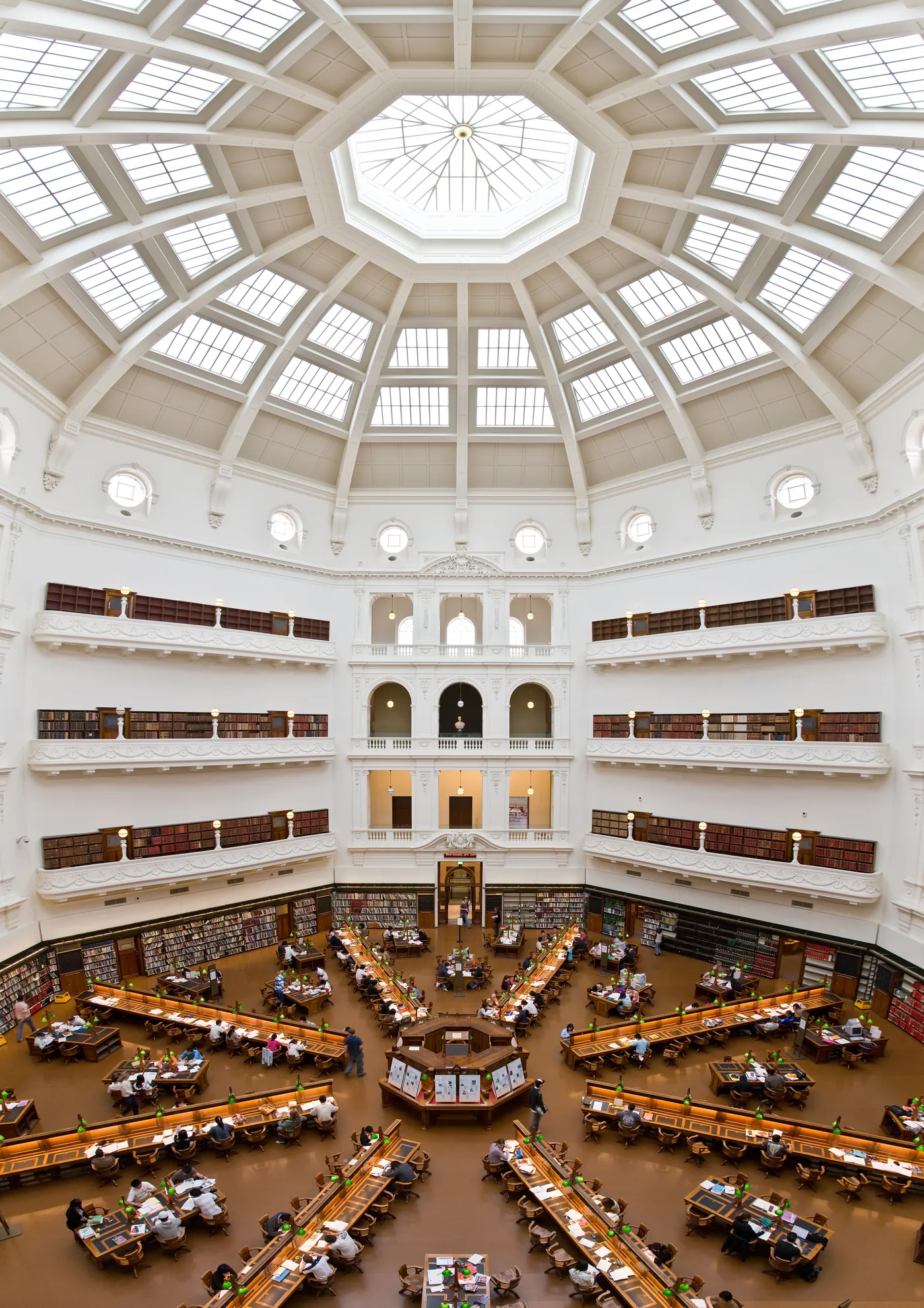 The octagonal La Trobe Reading Room at State Library Victoria seen from an upper balcony, desks radiating out from the centre beneath a glazed dome