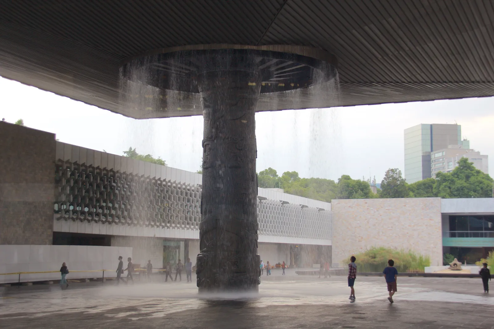The concrete canopy in the courtyard of the Museo Nacional de Antropología in Mexico City, carried on a single carved column with water falling from its rim onto the paving below