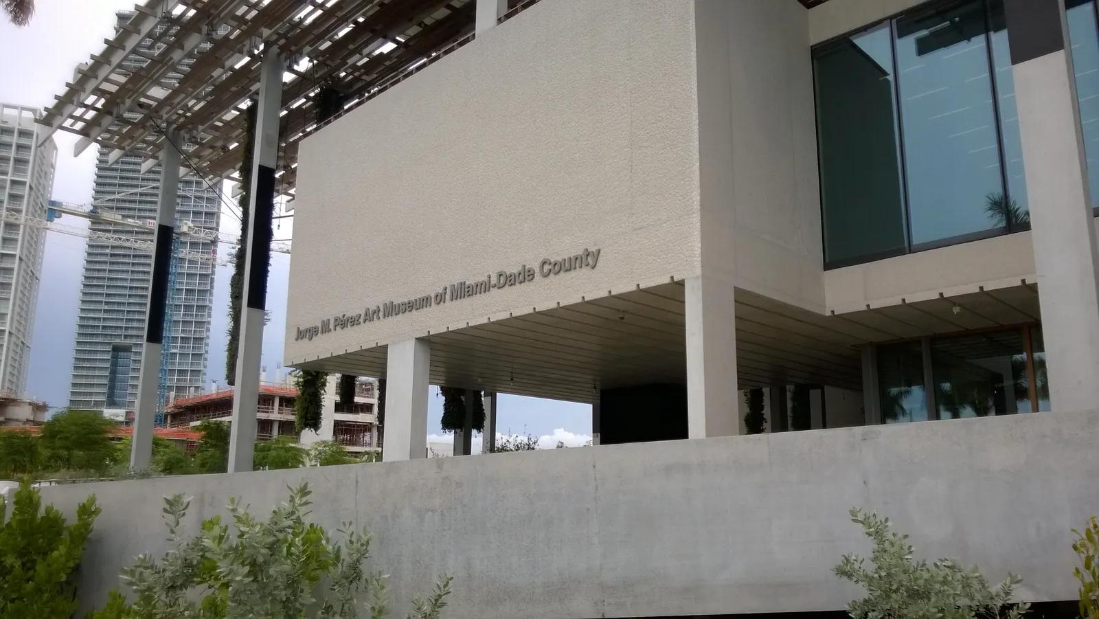 The elevated, column-lifted exterior of Pérez Art Museum Miami, with its shaded public plaza underneath