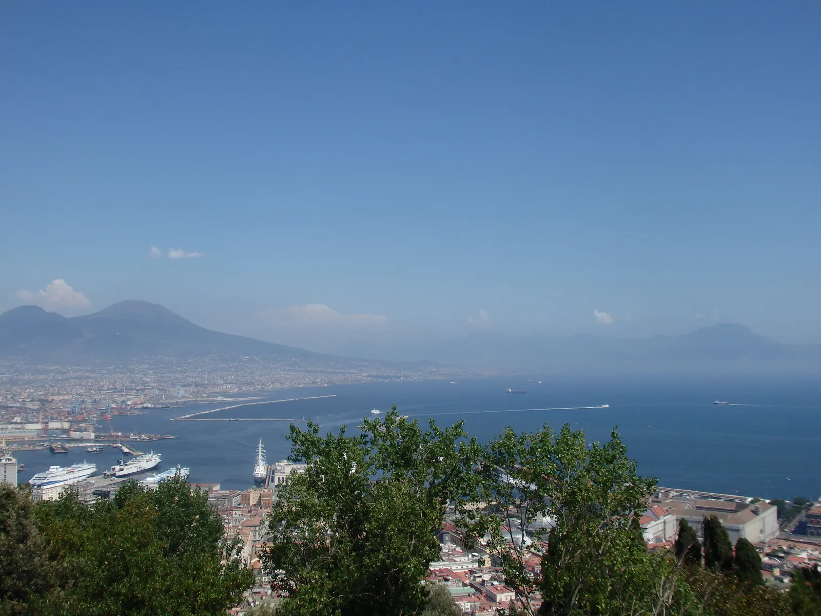 View over the Bay of Naples and Mount Vesuvius from the Vomero hill, with the port and rooftops below