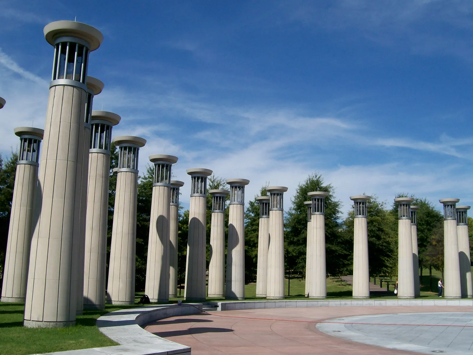 The ring of tall concrete bell columns of the 95-bell carillon at Bicentennial Capitol Mall in Nashville, standing around the edge of a paved circular plaza