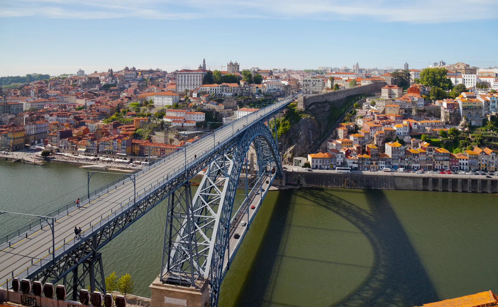 The double-deck iron Dom Luís I Bridge spanning the Douro river between Porto and Vila Nova de Gaia, with pedestrians on the upper deck