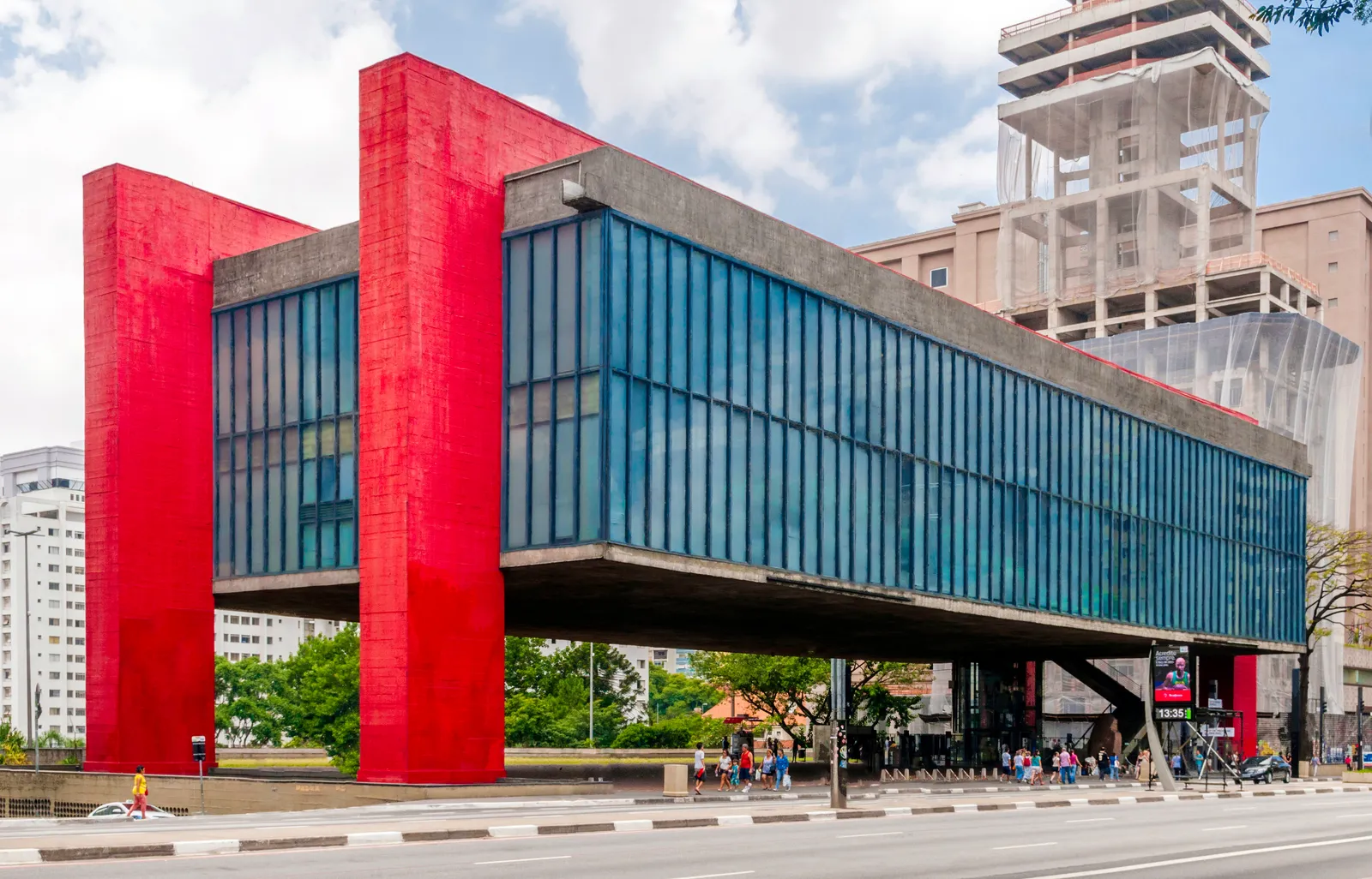 The São Paulo Museum of Art on Avenida Paulista, a glass and concrete box suspended between two pairs of bright red pillars with open paved space underneath it