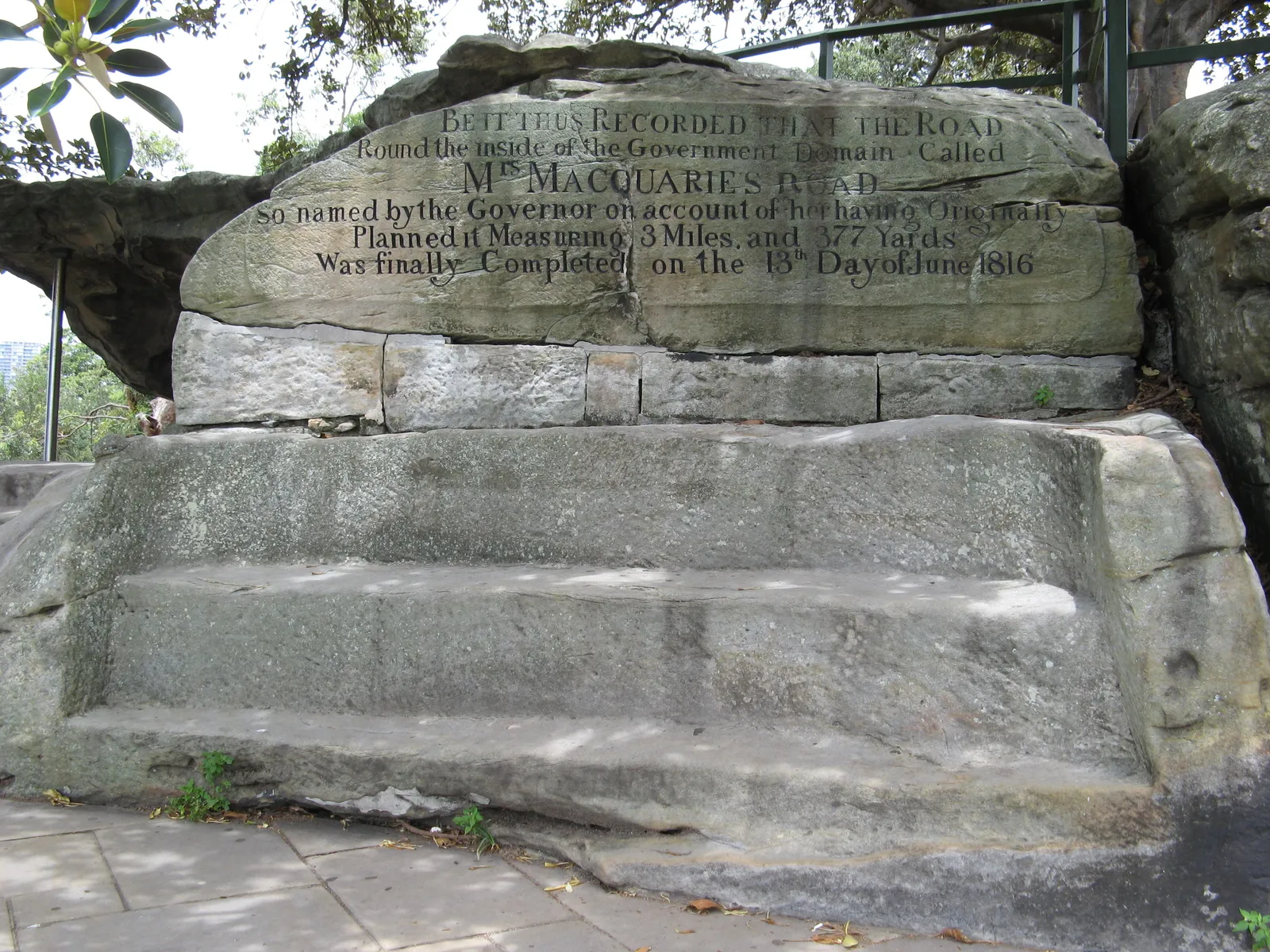 Mrs Macquarie's Chair in Sydney, a bench cut into a sandstone ledge with an inscription about Mrs Macquarie's road carved into the rock above it