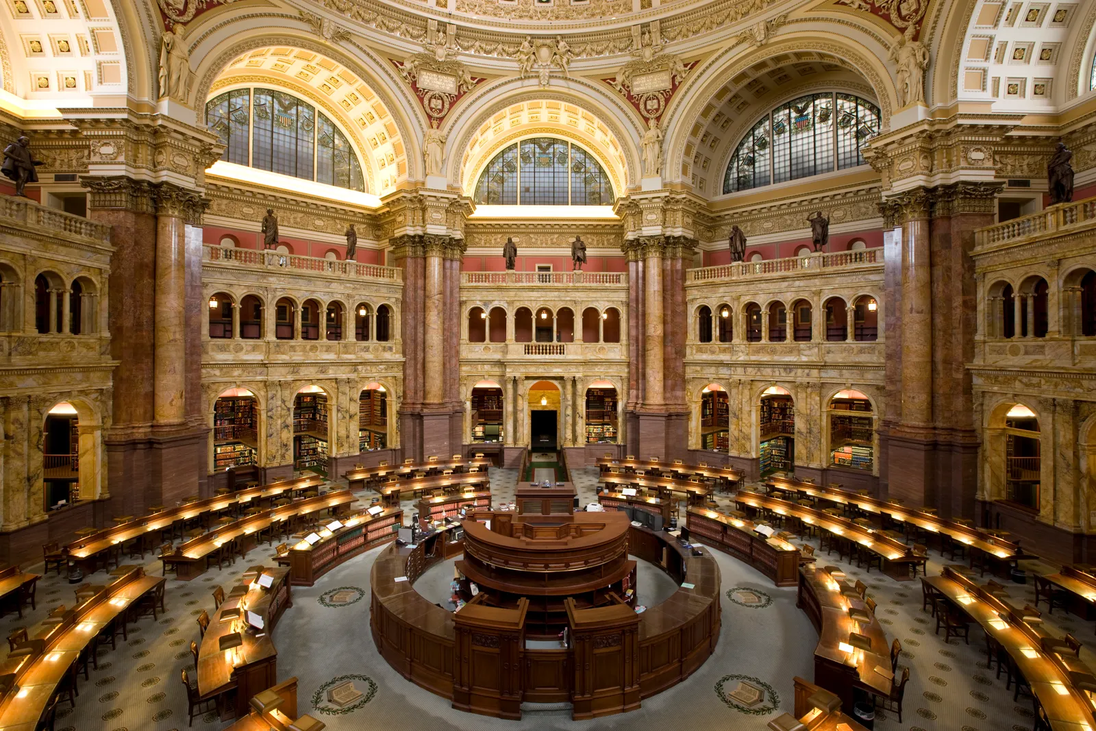 The Main Reading Room of the Library of Congress in Washington, a circular hall of marble columns and arched galleries with desks radiating out from a central island under the dome