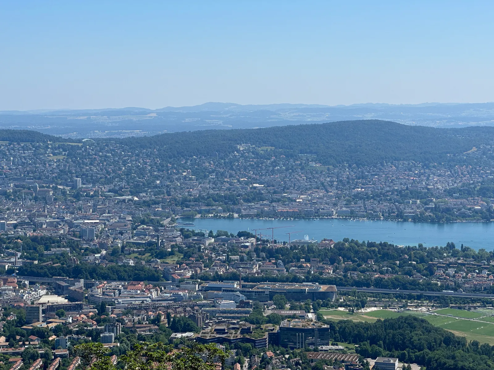 The view from Uetliberg down over Zurich, with the city spreading across the valley floor, the lake narrowing into the distance and wooded hills on either side