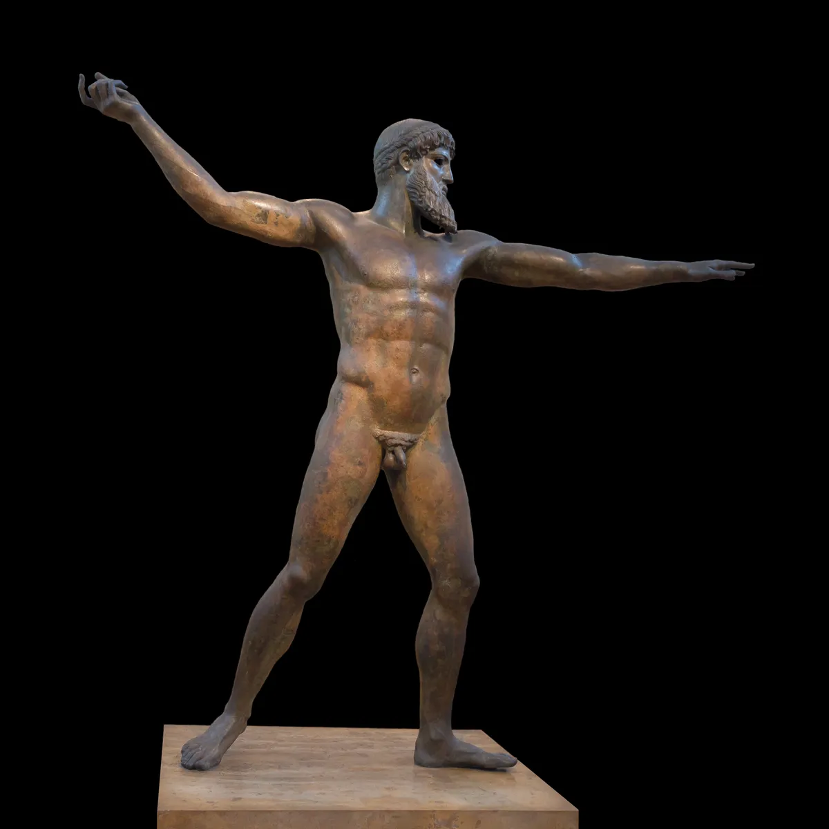 The Artemision Bronze, a bearded god striding with both arms outstretched, displayed against a black background