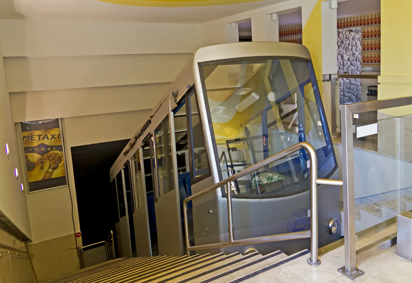 The small stepped funicular car waiting at the lower Lycabettus station in Athens at the mouth of its tunnel