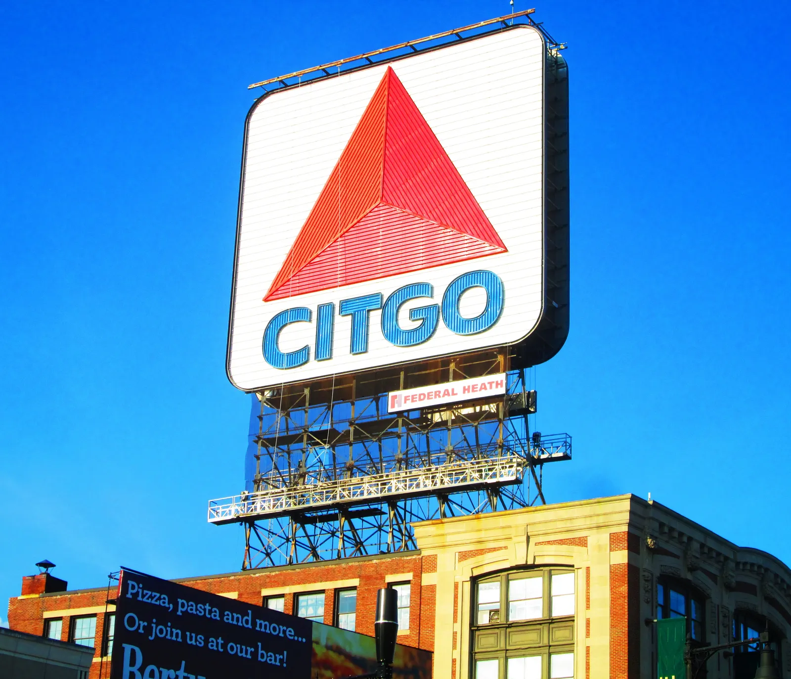 The Citgo sign over Kenmore Square in Boston, a square white panel carrying a red triangle and blue lettering, mounted on a steel frame above a brick building