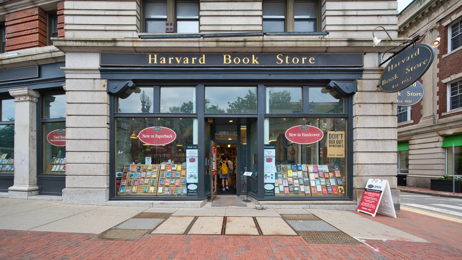 The shopfront of Harvard Book Store on Massachusetts Avenue in Cambridge, its name painted across the fascia above tall windows filled with book displays either side of an open door