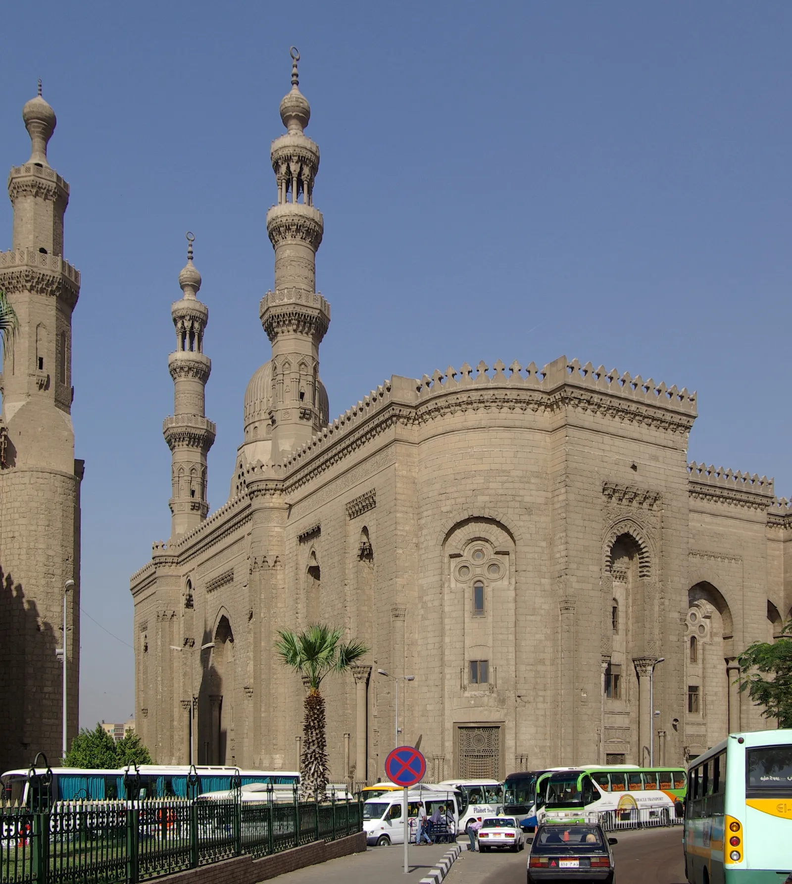 The Al-Rifa'i mosque in Cairo from the square outside, a pale stone building in Mamluk revival style with a domed mausoleum block and two tall minarets