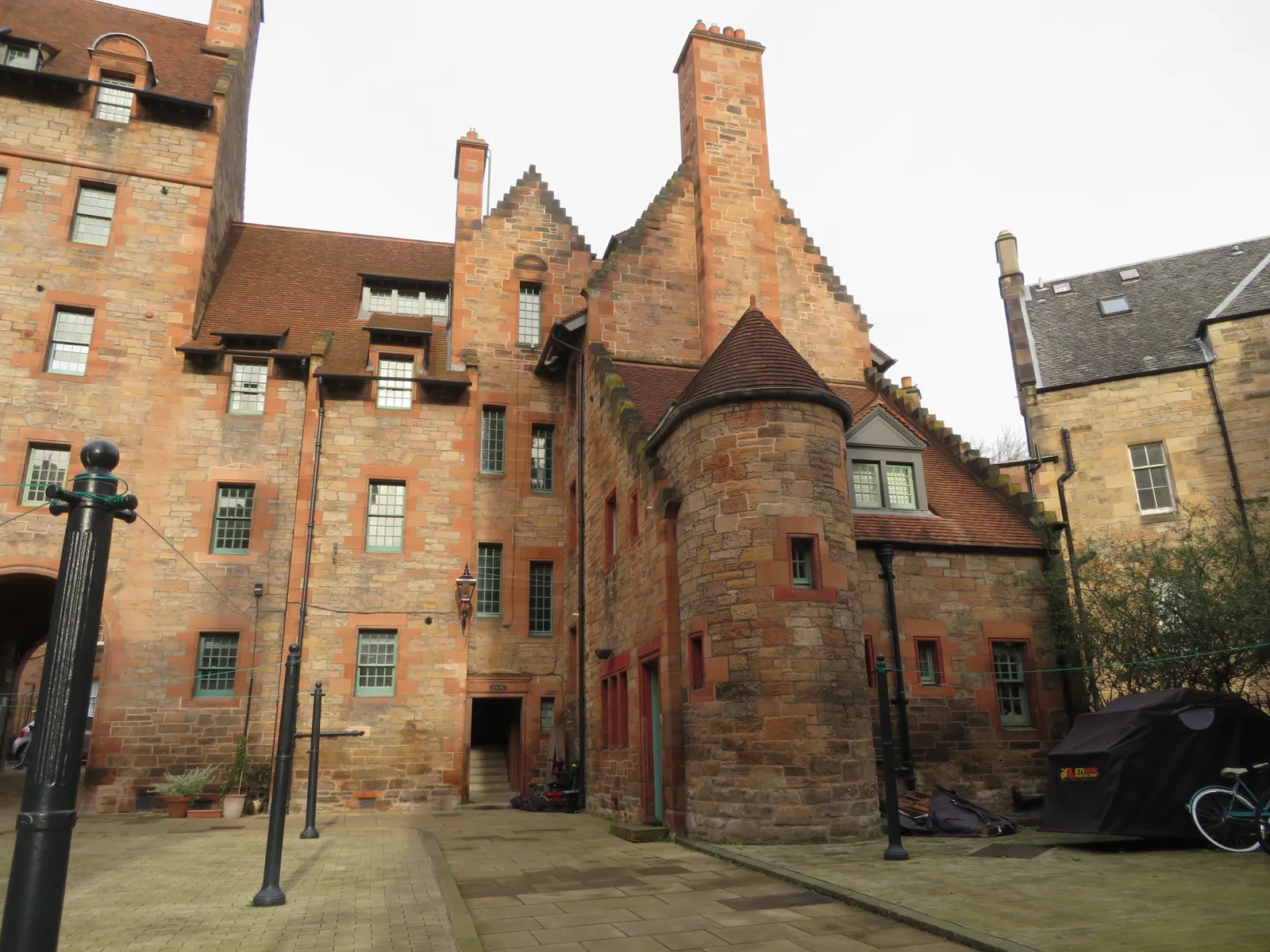 The turreted red sandstone tenement of Well Court in Dean Village, Edinburgh