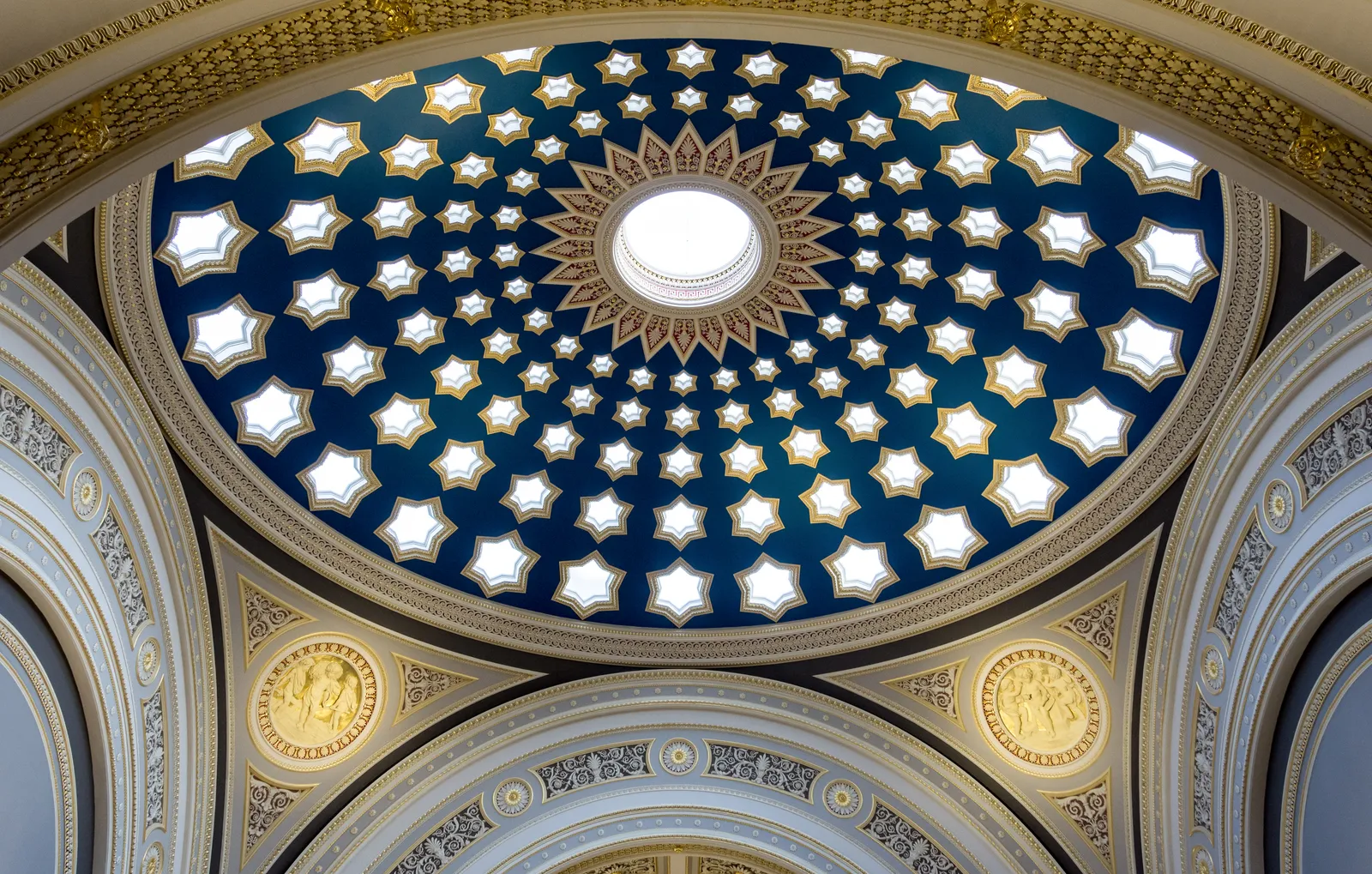 The blue dome over the banking hall at Dundas House in Edinburgh, pierced by five tiers of gold-rimmed star-shaped skylights radiating out from a central oculus