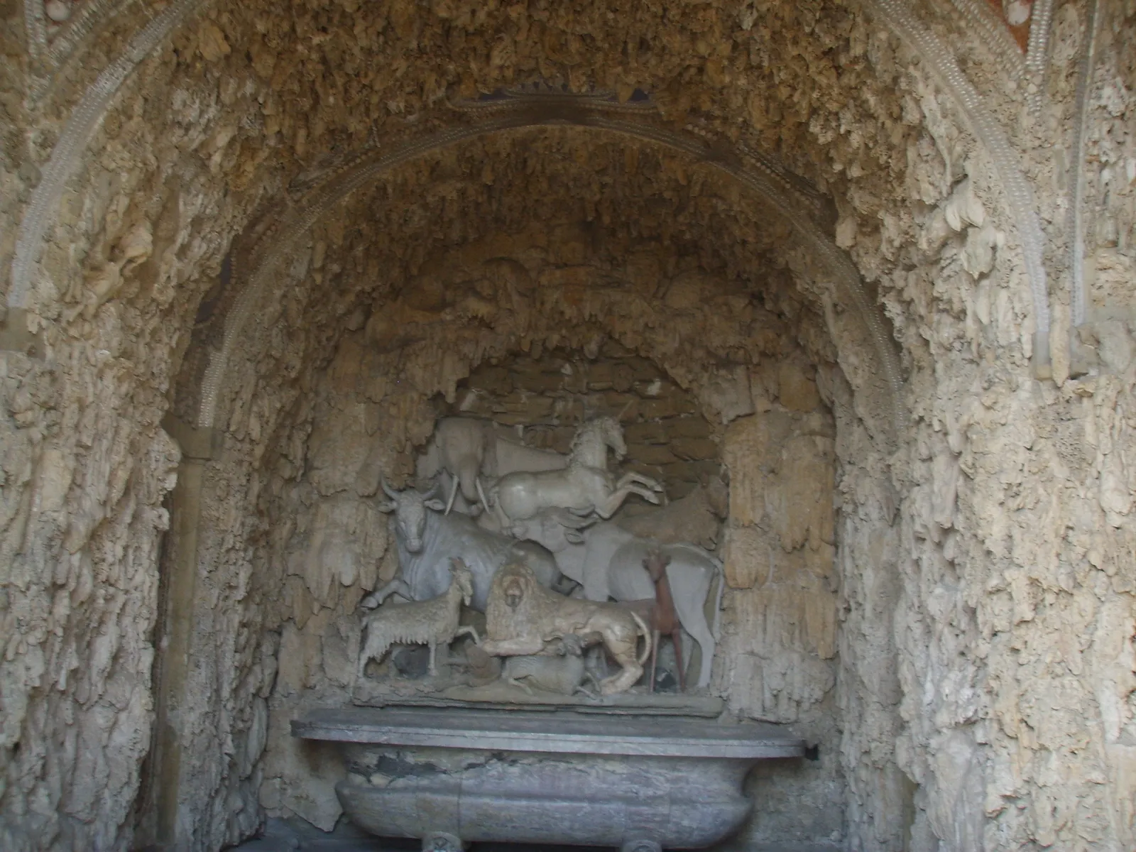Carved stone animals crowded into a niche of the Grotto of the Animals in the garden of Villa di Castello near Florence