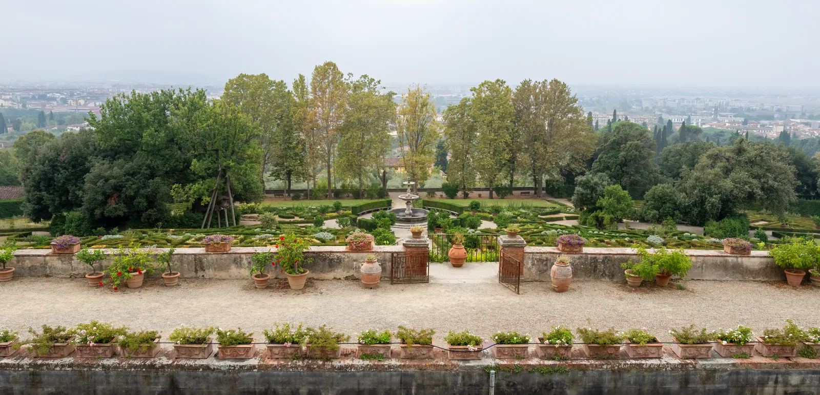 The terraced garden of Villa La Petraia above Florence, with potted citrus trees along a stone balustrade and box-edged parterres below