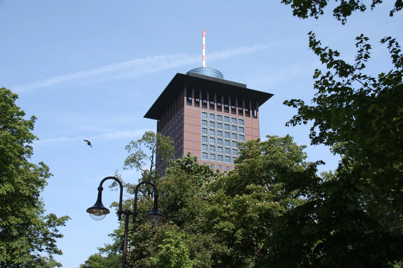 The Japan Center's dark terracotta tower with its stepped, pagoda-like crown rising above the trees of Taunusanlage park