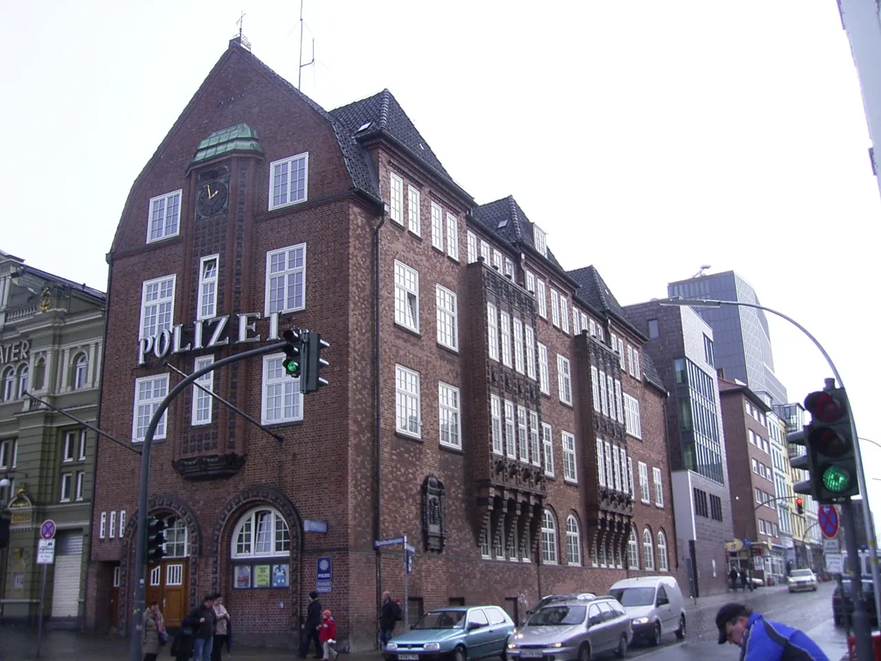 The red-brick Davidwache police station in Hamburg on its street corner, a steep-gabled building with POLIZEI lettering down one wall