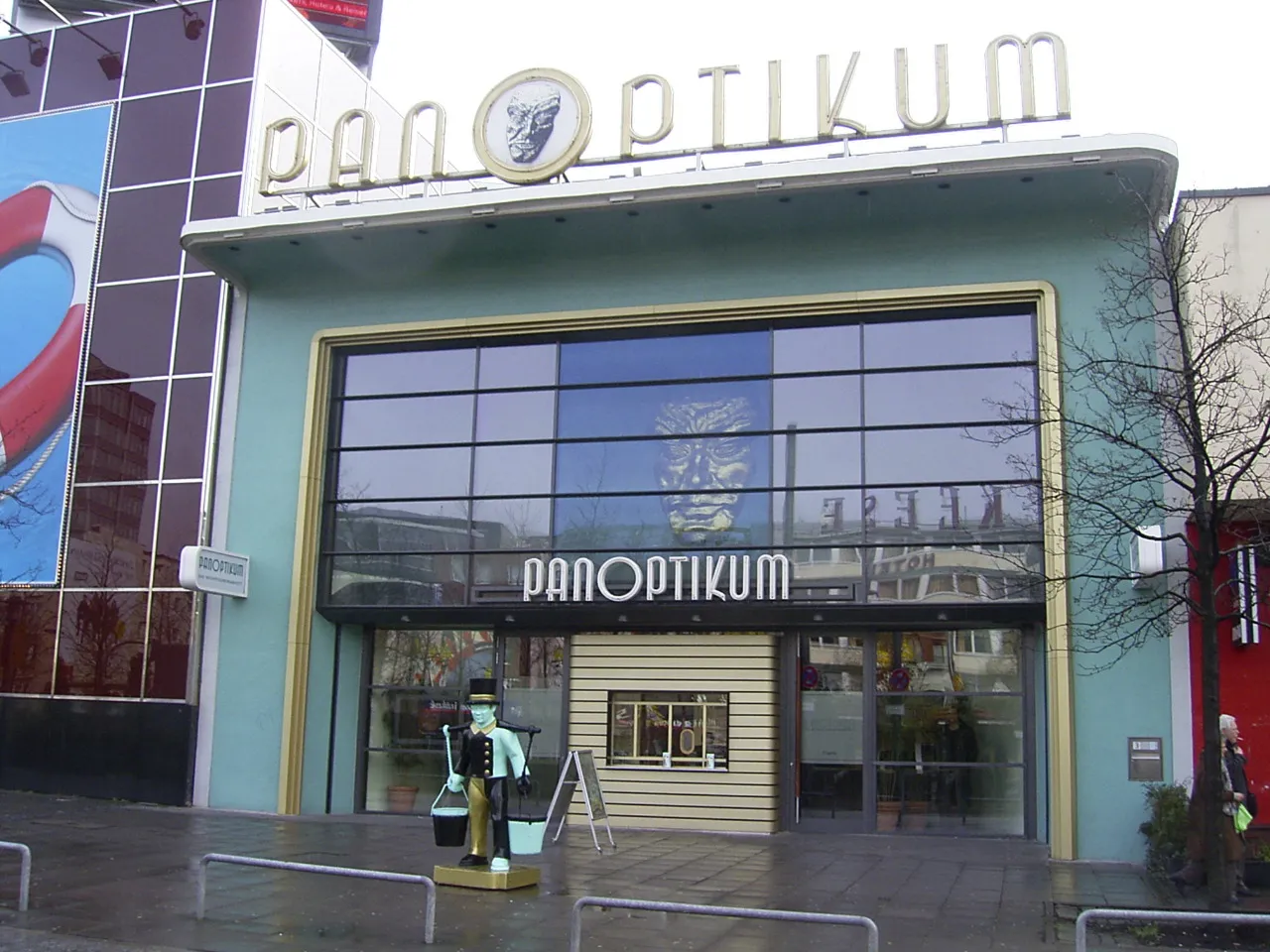 The pale green frontage of the Panoptikum waxworks on Spielbudenplatz in Hamburg, with its name in large letters above a glazed entrance