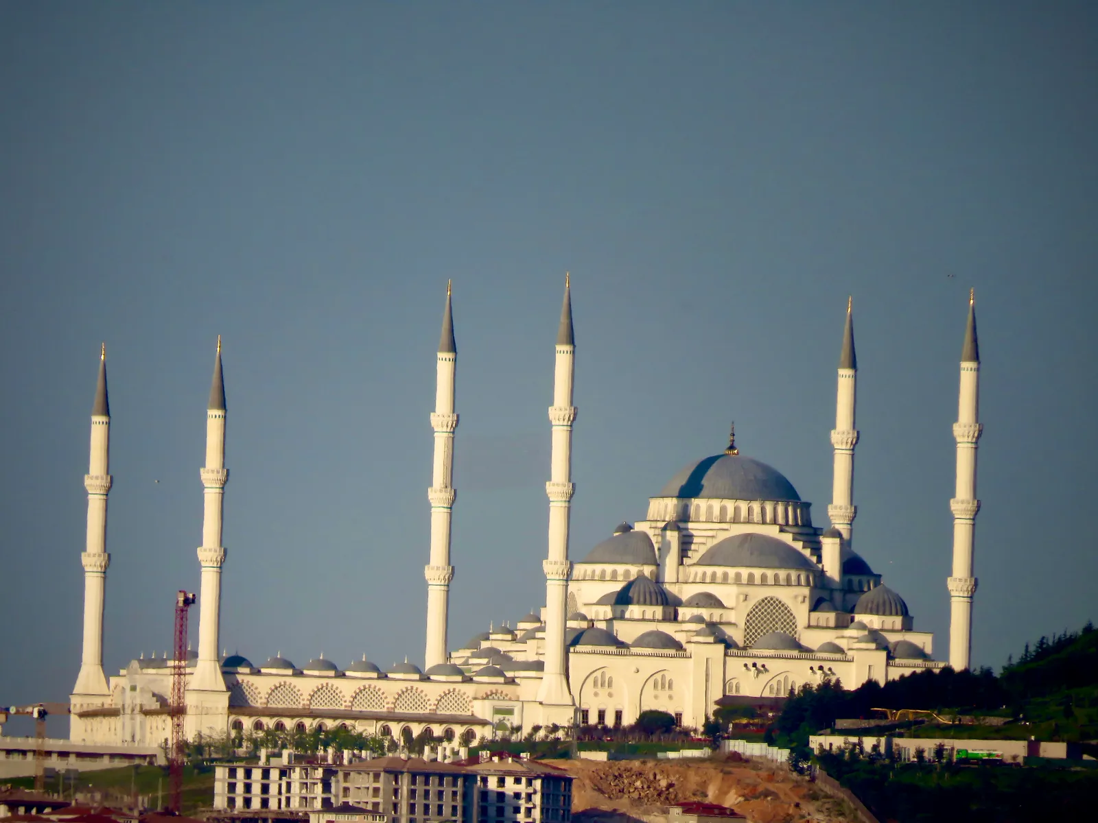 Çamlıca Mosque on its hilltop above Üsküdar, a very large blue-domed mosque with six tall white minarets around it, standing above wooded slopes