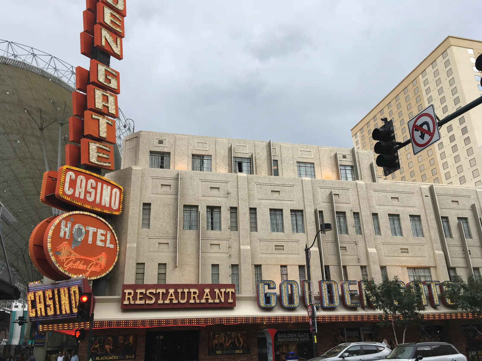 The Golden Gate Hotel and Casino in downtown Las Vegas, a cream art deco building with a tall vertical neon sign reading GOLDEN GATE CASINO HOTEL down its corner