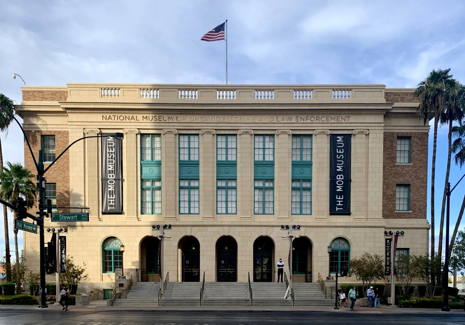 The Mob Museum in Las Vegas, a 1933 neoclassical courthouse in pale stone with arched ground-floor windows, a flag on the roof and NATIONAL MUSEUM OF ORGANIZED CRIME AND LAW ENFORCEMENT carved across the front