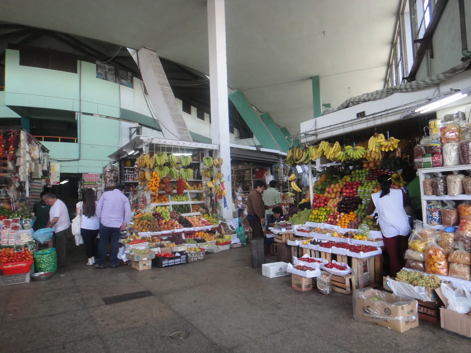 Fruit and vegetable stalls stacked with bananas, citrus and chillies inside the covered hall of Surquillo's Mercado Número 1 in Lima