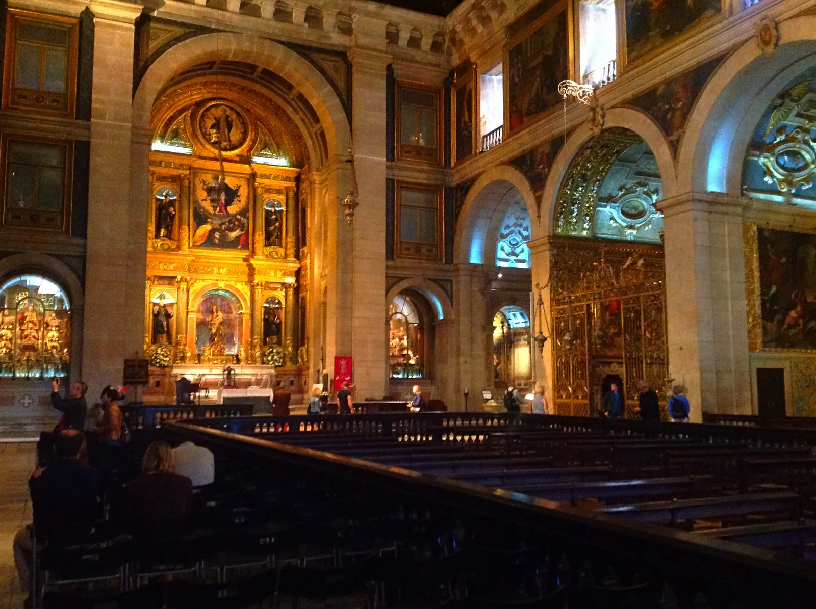 The interior of São Roque church in Lisbon, with gilded side chapels along a plain nave under a painted flat ceiling