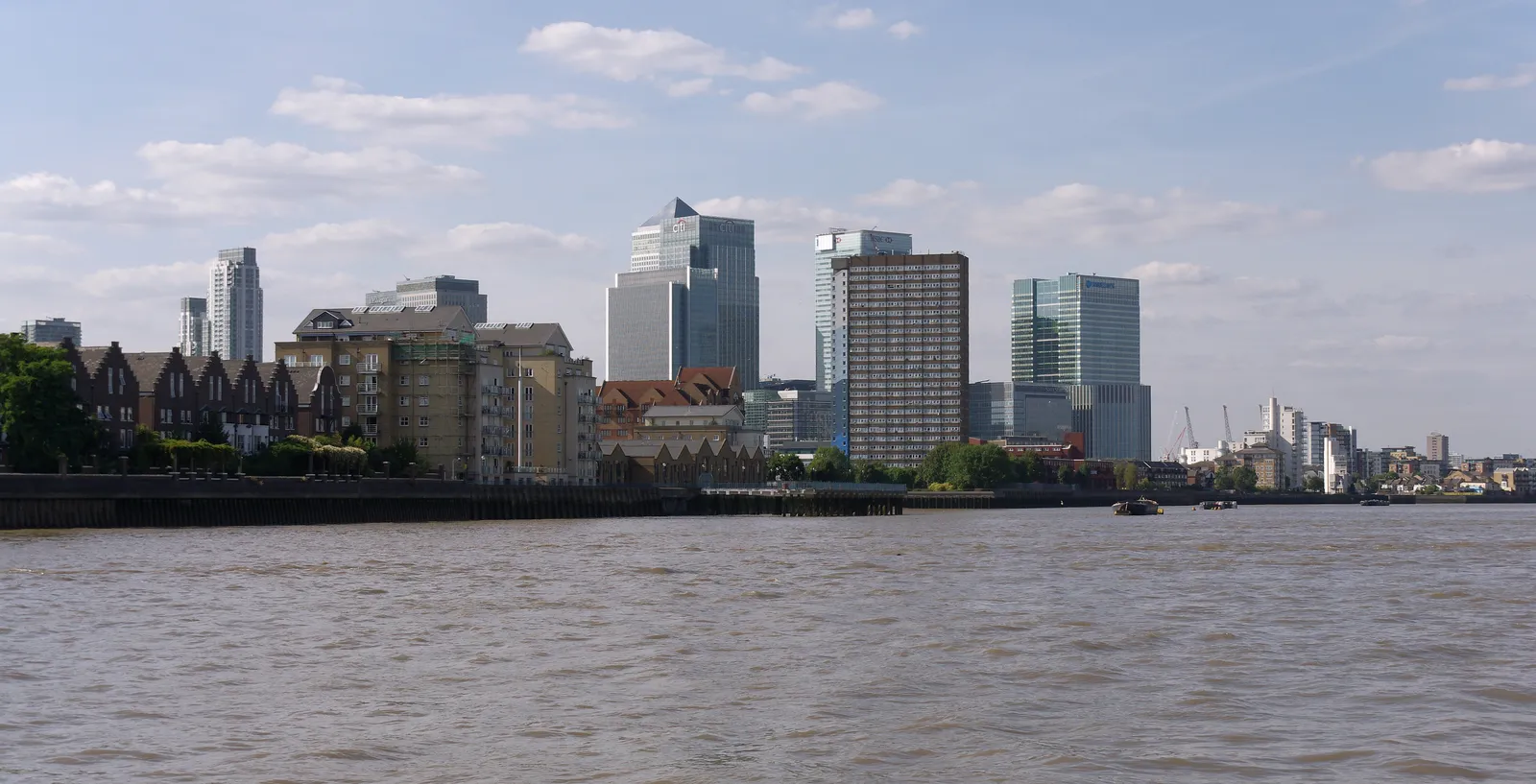 The glass towers of Canary Wharf seen across the River Thames on a clear day