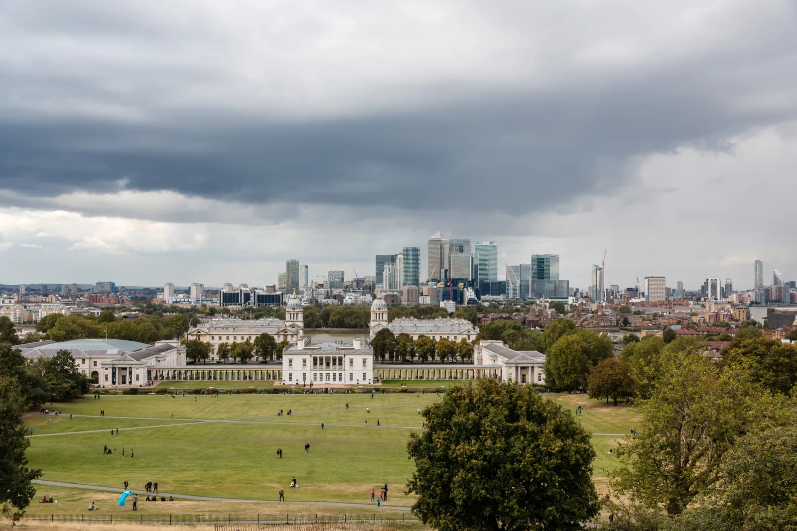 The view from the top of Greenwich Park over the Old Royal Naval College toward the Canary Wharf skyline