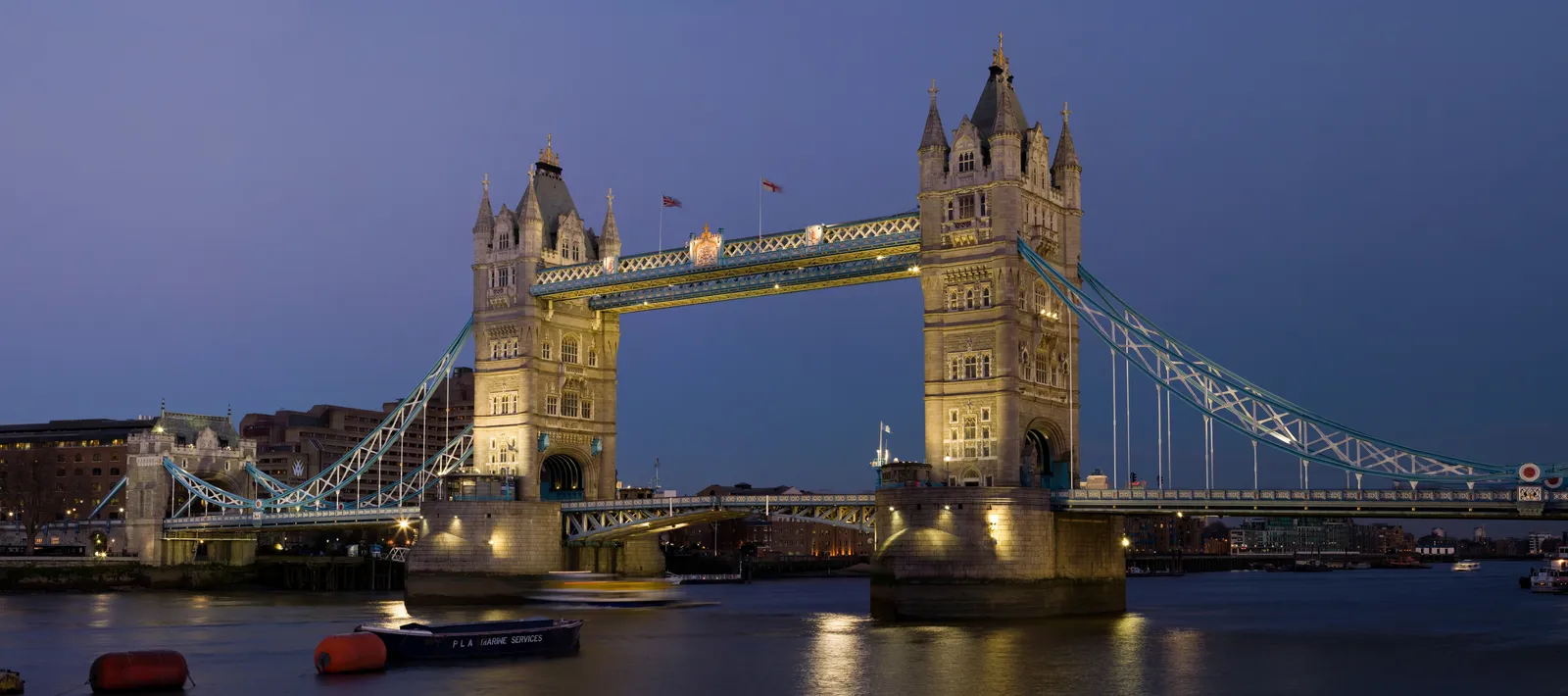 Tower Bridge illuminated over the River Thames at dusk in London