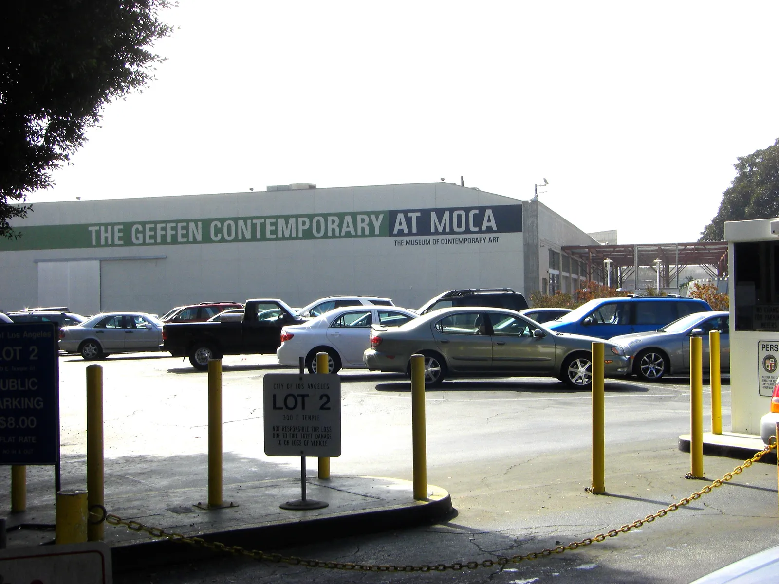 The Geffen Contemporary at MOCA in Los Angeles, a long low grey warehouse with the museum's name painted in large letters along the wall above a street-level car park
