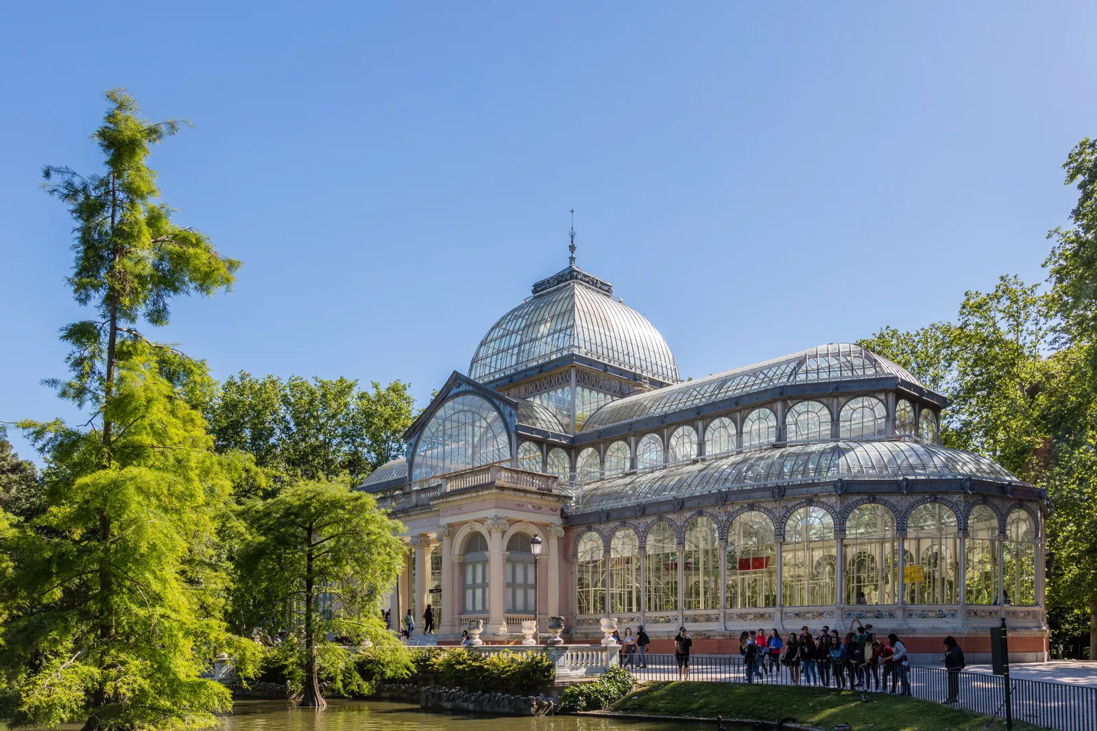 The glass-and-iron Palacio de Cristal beside its lake in Madrid's Retiro Park