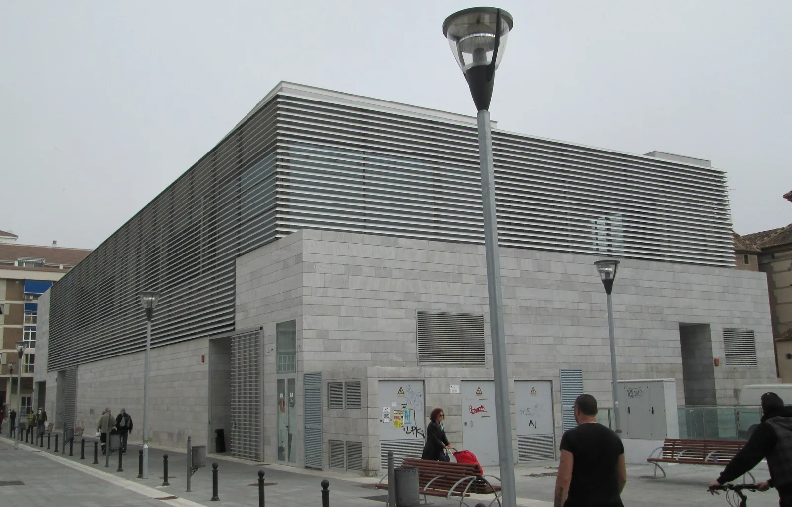 The modern grey stone exterior of Mercado del Carmen, El Perchel's covered food market in Málaga