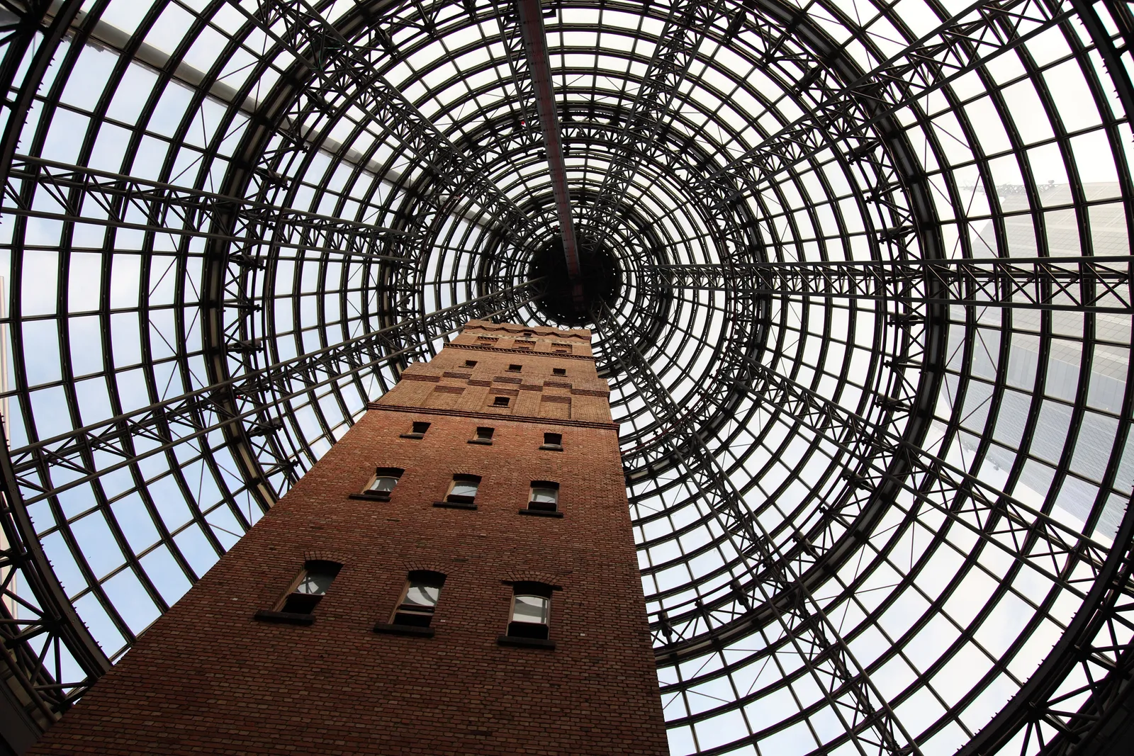 Coop's Shot Tower in Melbourne, a nine-storey brick tower photographed from its base looking up into the conical glass and steel roof built over it