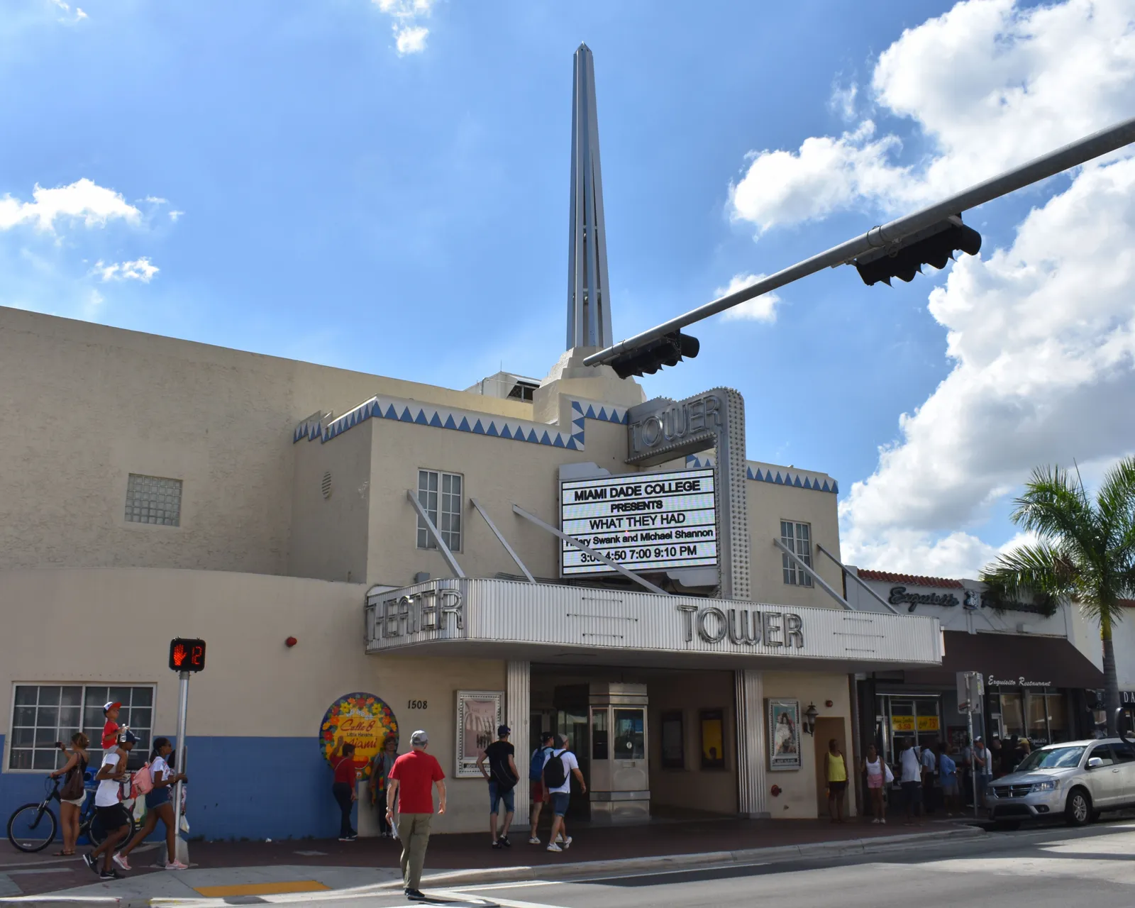 The Tower Theater on Calle Ocho in Little Havana, Miami, an Art Deco cinema with a marquee over the entrance and a tall white steel spire rising from the roof