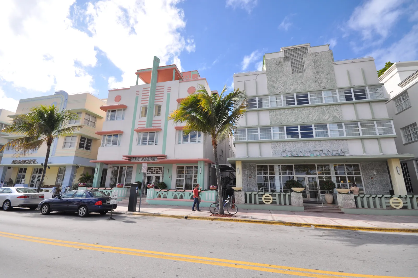 Pastel-colored Art Deco hotels lining Ocean Drive in Miami Beach, with palm trees along the sidewalk
