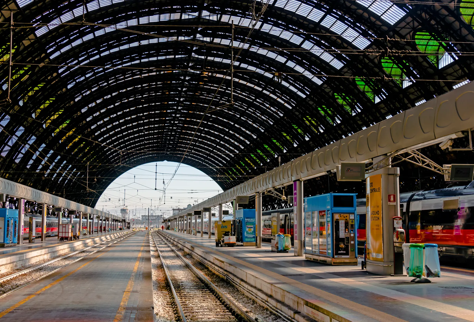 The vaulted iron-and-glass trainshed roof over the platforms at Milano Centrale station