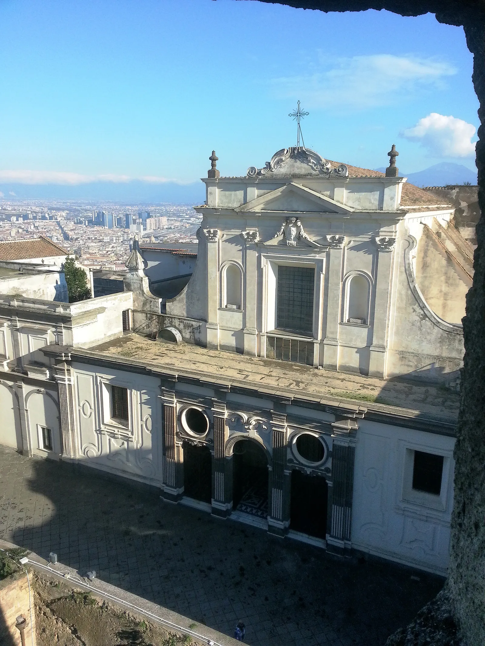 The baroque facade of the Certosa di San Martino church with Naples and the bay spread out below