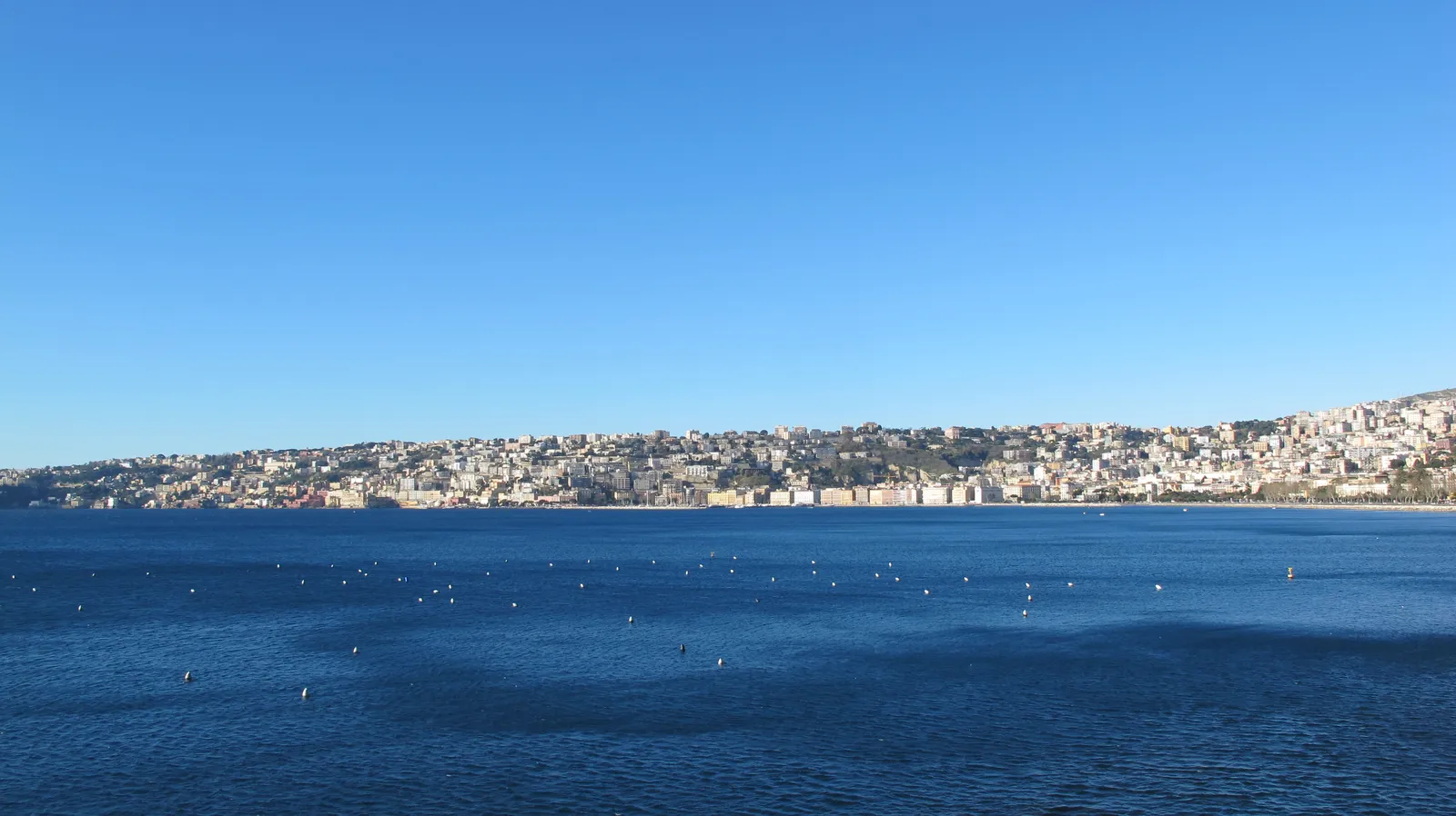 The Posillipo hillside and coastline of Naples seen across the bay from the Mergellina waterfront