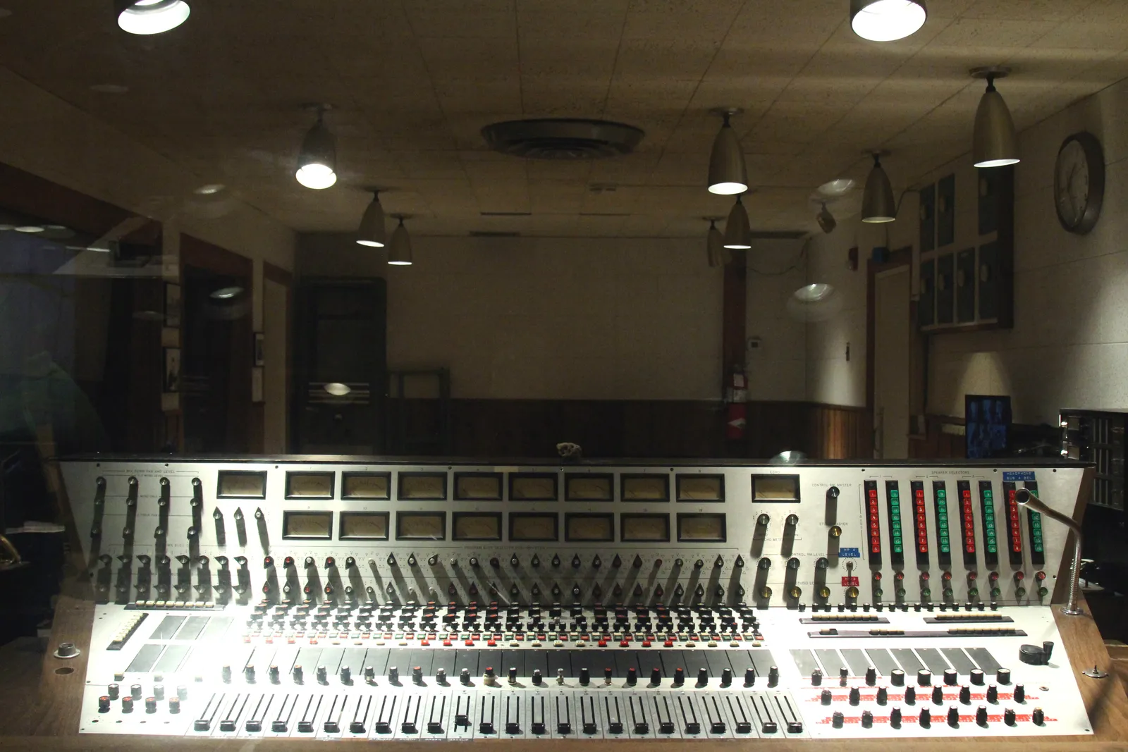The mixing console in RCA Studio B's control room in Nashville, banks of faders and switches in front of a window looking through into the studio floor
