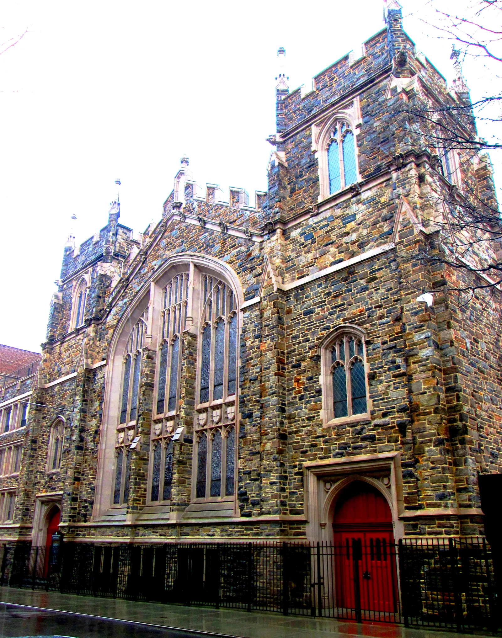 The Abyssinian Baptist Church on West 138th Street, a Gothic church built from rough multicoloured stone with a tall traceried window and red doors