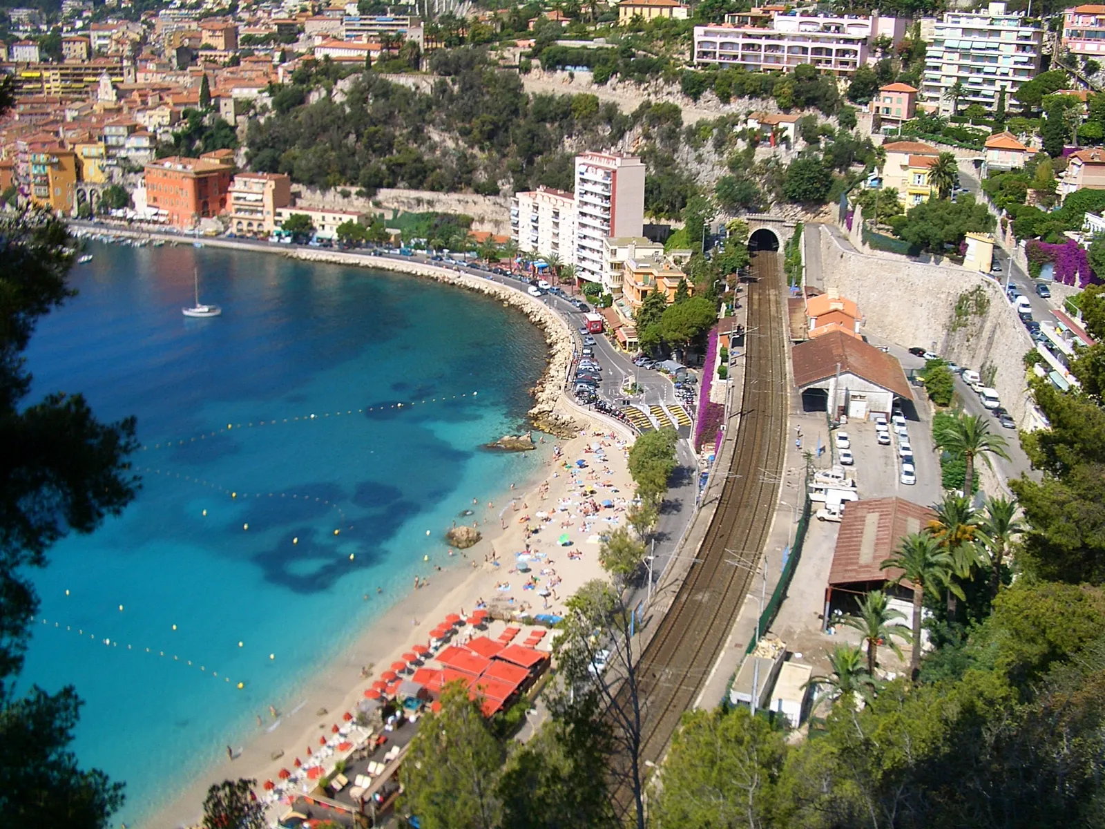 Villefranche-sur-Mer's train station and tunnel entrance perched directly above its sandy beach